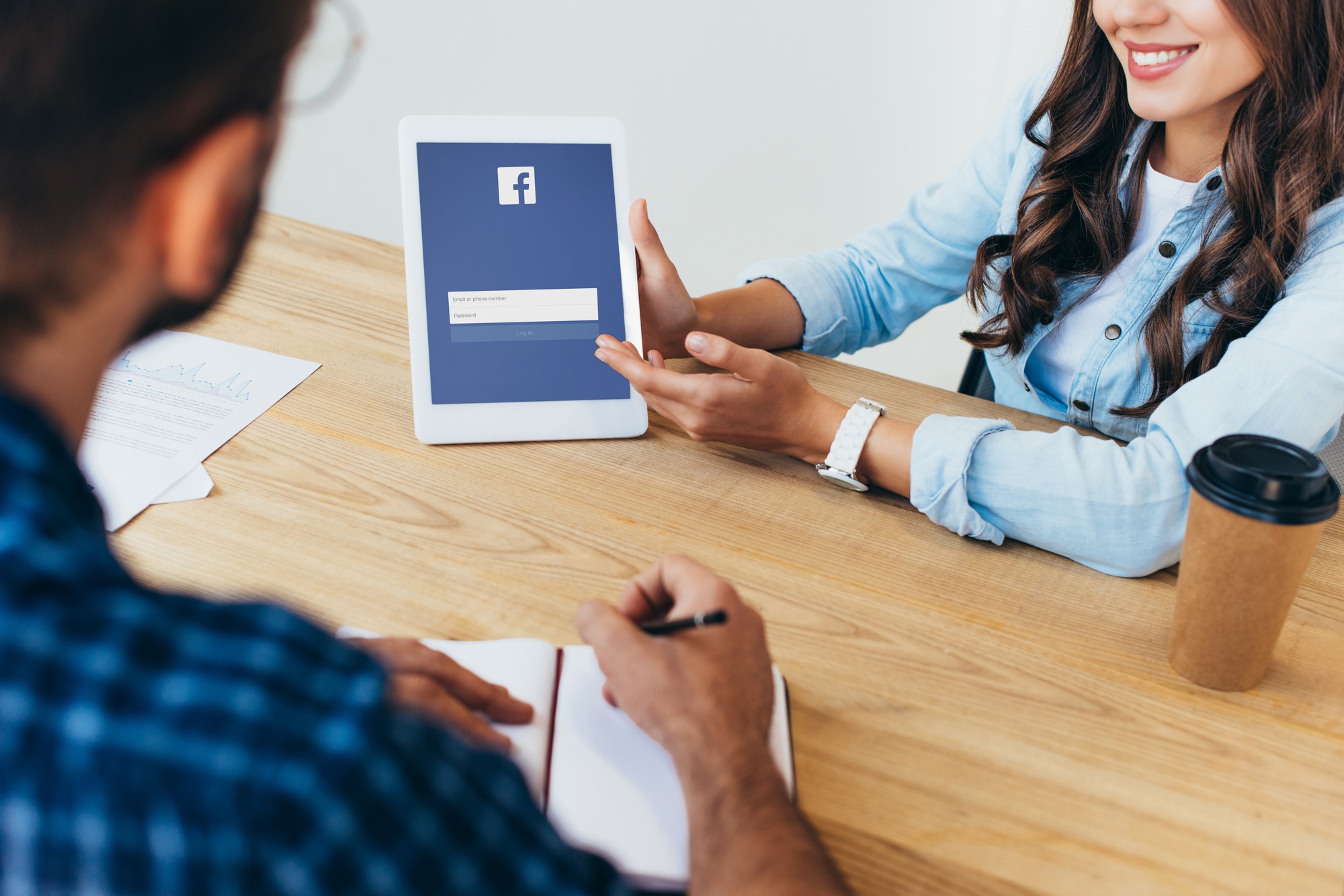 Colombia Marketplace Partial View of Businesswoman with Tablet with Facebook Logo and Colleague with Notebook Taking Part » Marketplace Colombia Colombia Marketplace Partial View of Businesswoman with Tablet with Facebook Logo and Colleague with Notebook Taking Part