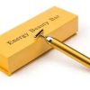Gold Energy Beauty Bar Packaging with a Matching Gold Facial Wand Laid Across the Box