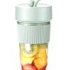 Portable Blender Bottle with a Green Lid, Filled with Kiwi, Pineapple, and Strawberry Pieces