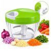 Green Manual Vegetable Chopper with a Clear Bowl and Stainless Blades, Shown with Chopped Onions, Garlic, Carrot, and Herbs Nearby to Suggest Use for Prepping Vegetables.