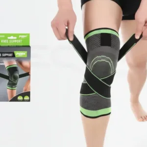 Person wearing a black and green knee support wrap on the right leg, straps being fastened, product box shown nearby.