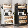 Two Mobile Kitchen Carts (white on Left, Black on Right) with Jars on Top, a Microwave and Kettle Inside, and Glass-front Drawers with Dishes Below Docked in a Marble-tiled Kitchen.