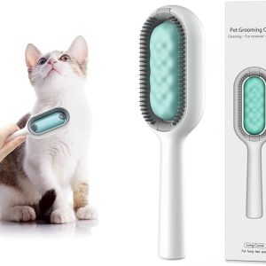Cat Being Groomed with a White-and-teal Pet Grooming Brush; Hand Holding the Brush Against Its Fur.