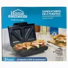 Box of a Home Elements Sandwich Maker for 2 Slots; Antiadhesive Plates and Compact Storage Claim in Spanish/english Text Visible on Packaging
